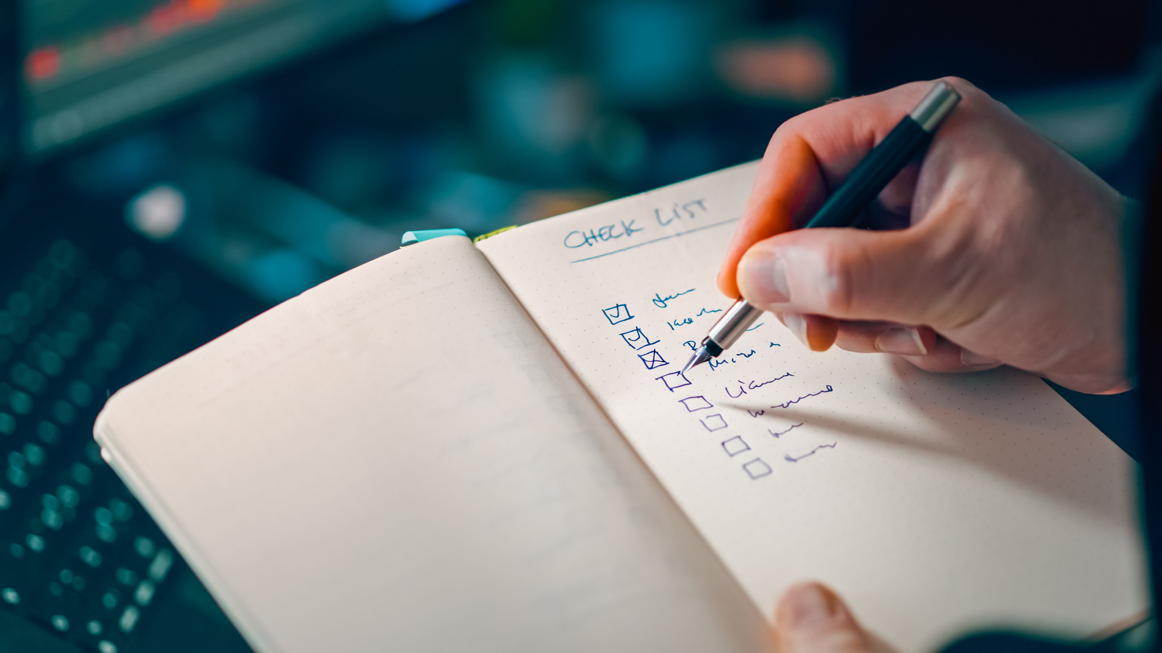 A hand checking off items on a written task list, representing an agent working through a standing plan