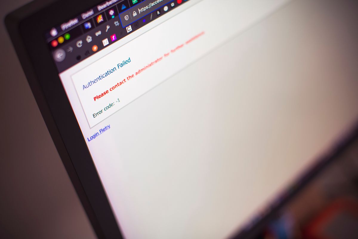 A close-up of a laptop screen displaying an authentication failed error message