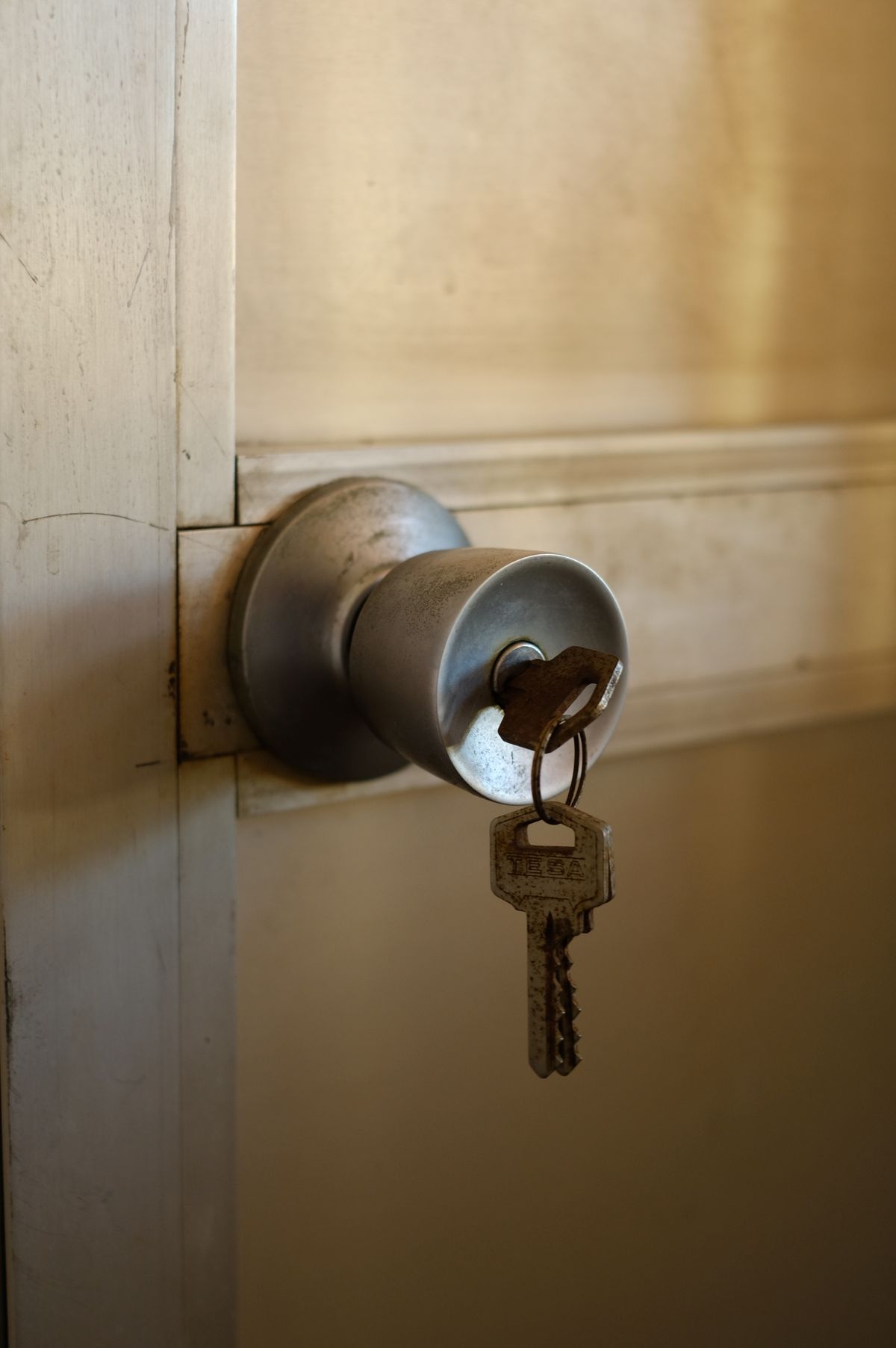 A key left sitting in an unlocked metal door knob