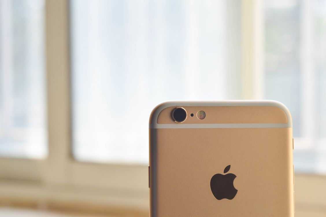Close-up photograph of a smartphone camera lens catching sunlight