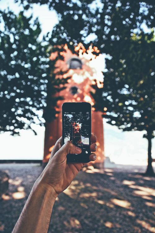 A person holding an iPhone, using it to look something up rather than typing a traditional search query
