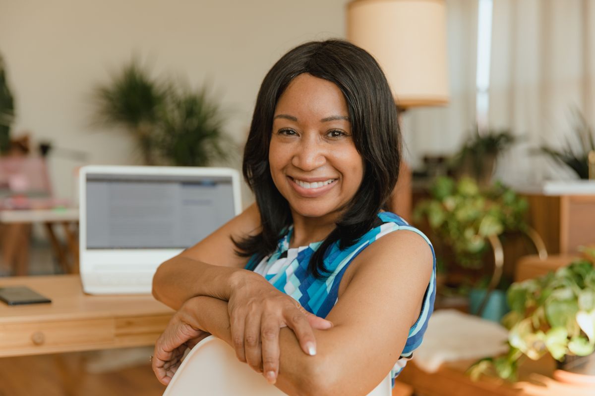 A person smiling calmly and confidently at a desk, the relaxed feeling of trusting one well-understood bot job rather than juggling several unproven ones